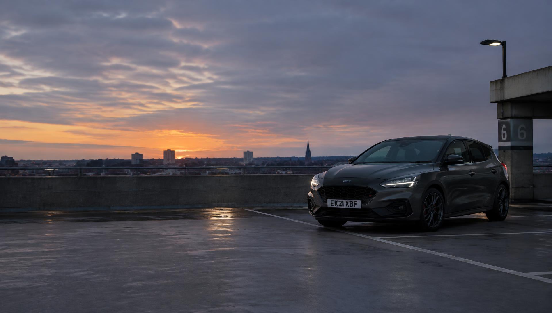 Car parked on the top deck of a UK multi-storey car park at dusk